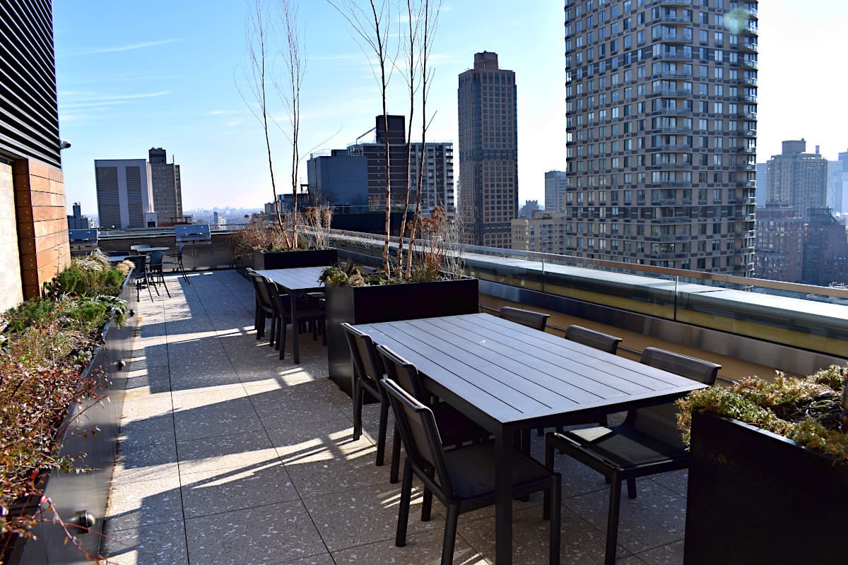 Rooftop dining terrace bordered by integrated planters