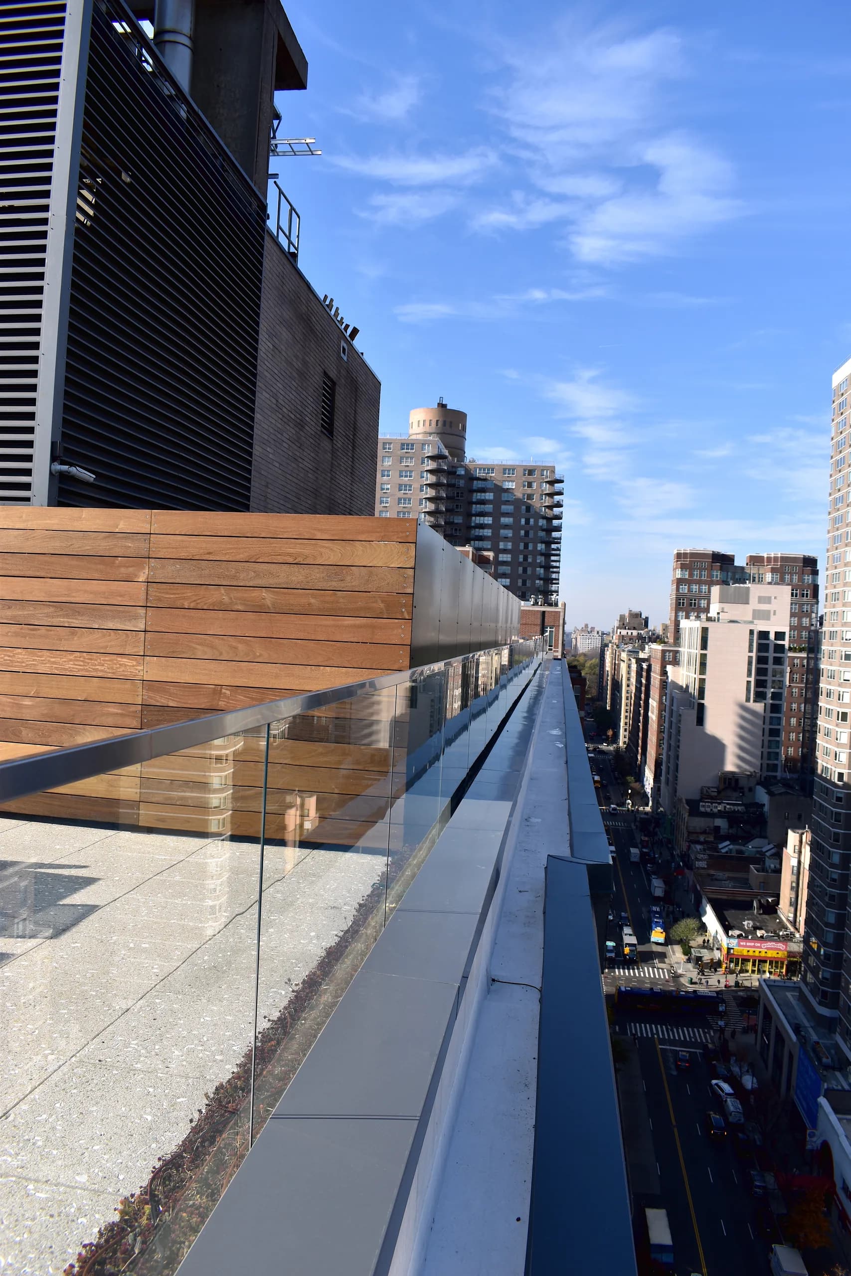 Glass rooftop railing overlooking East 86th Street