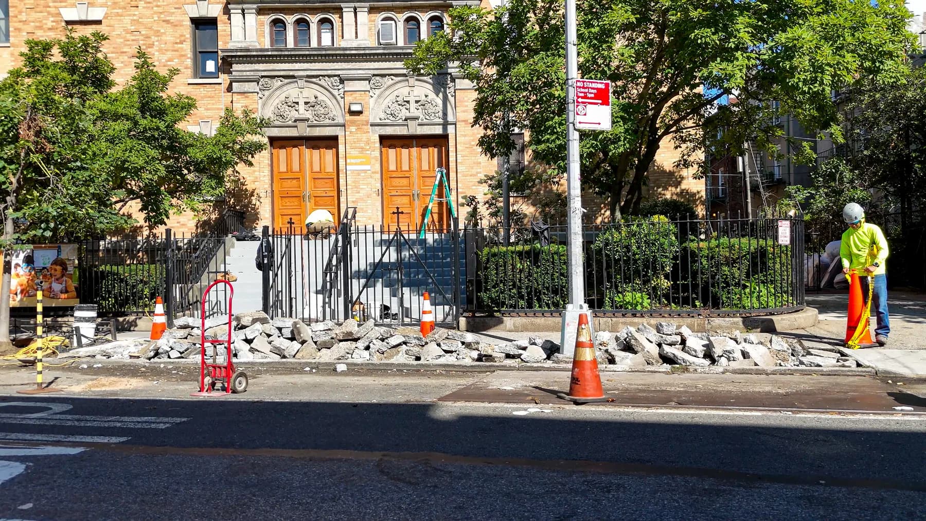 Wide view of sidewalk work in progress outside the entrance of St. Matthias RC Church