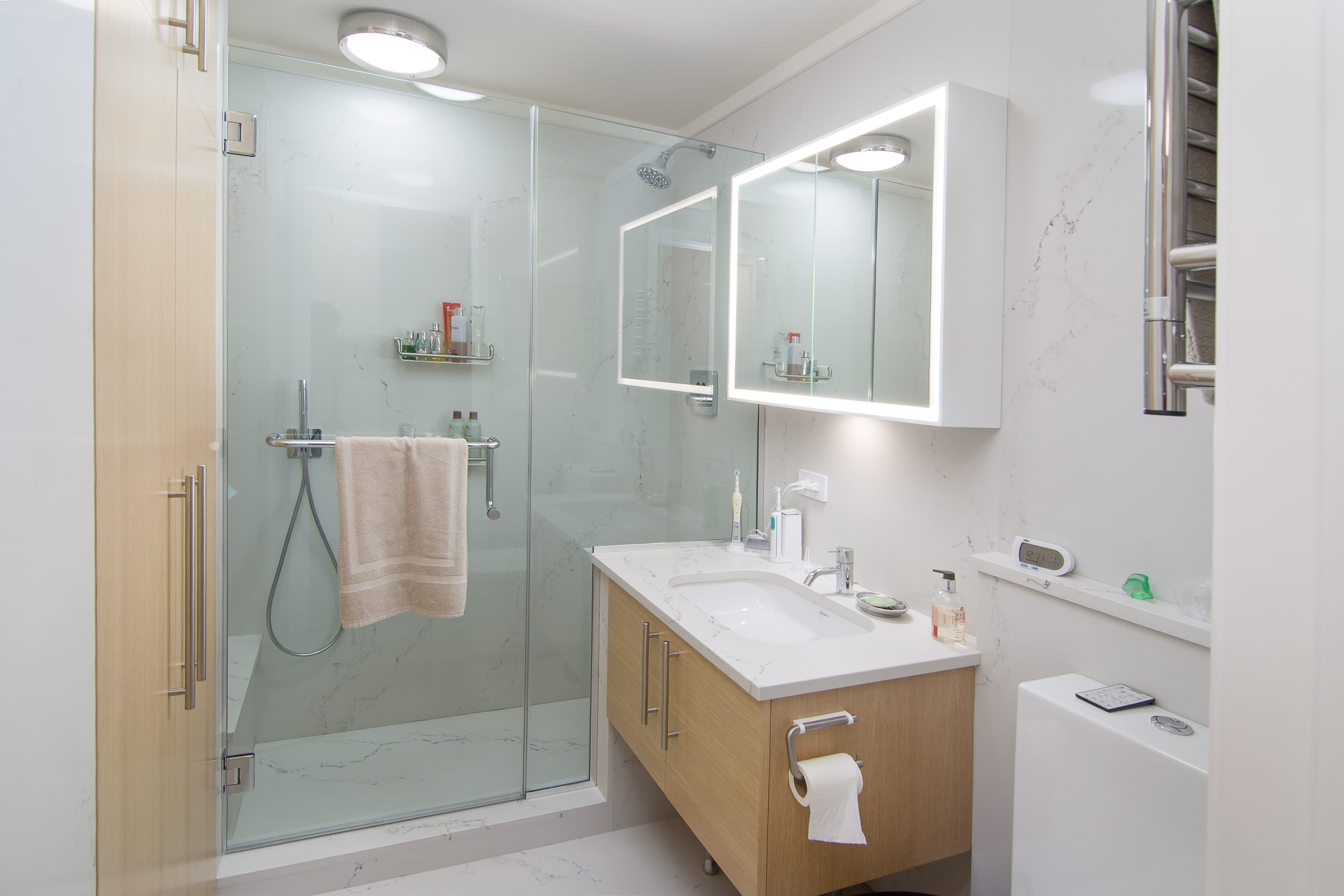 Custom oak vanity and integrated bathroom cabinetry