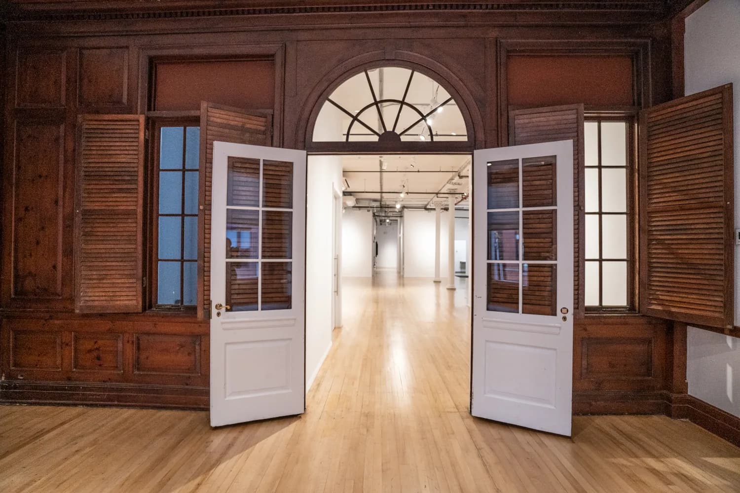 Retained wood paneling and arched transom opening