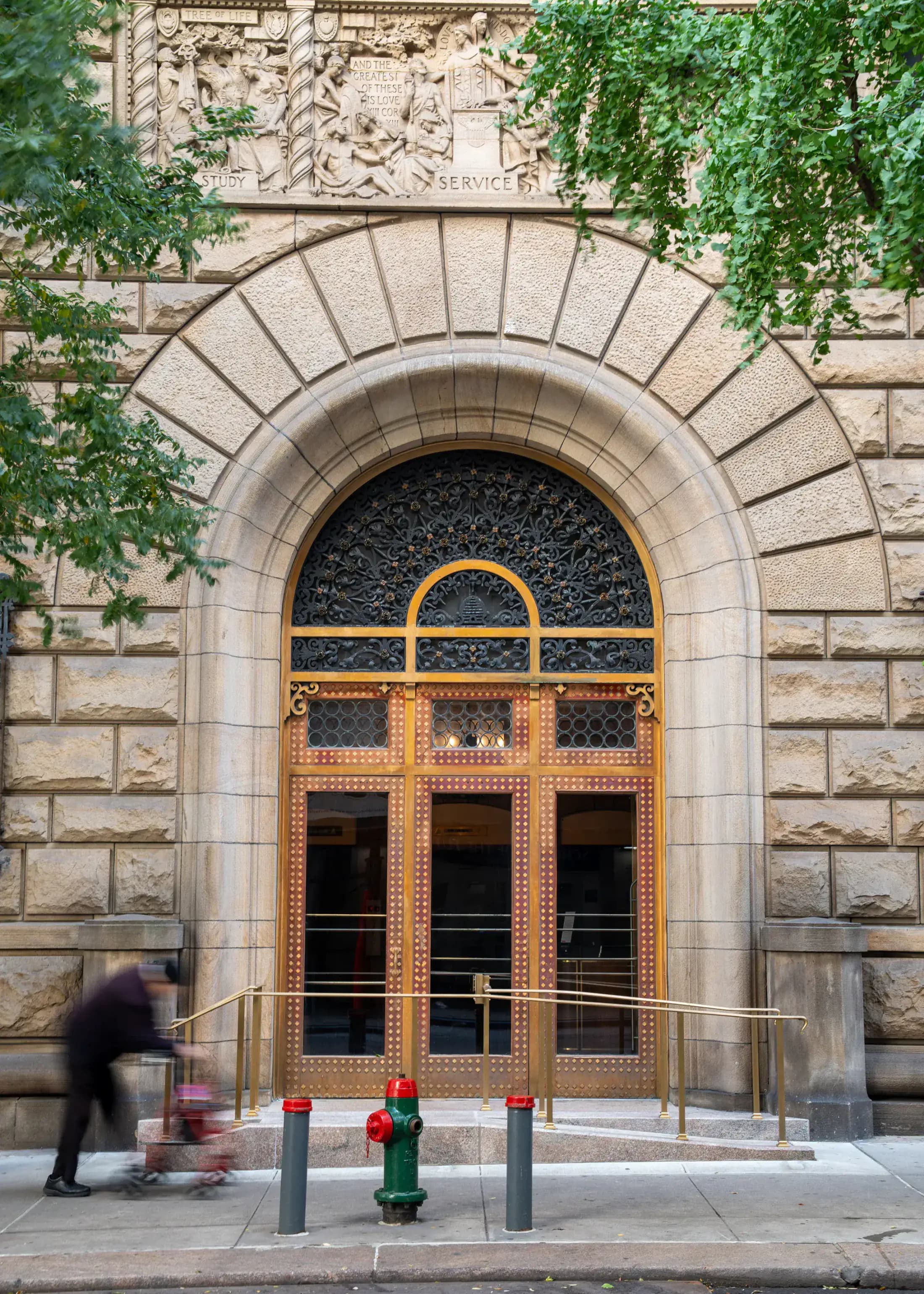 Monumental arched entrance and ornate doors at 4 Lexington Avenue in Manhattan