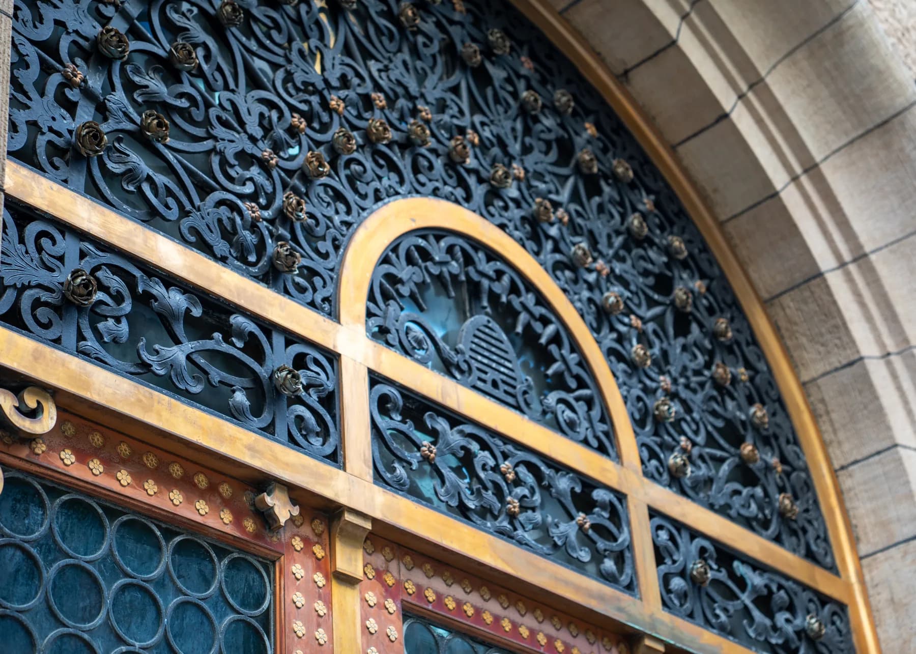 Ornamental iron grille and gold arch detail above the entrance