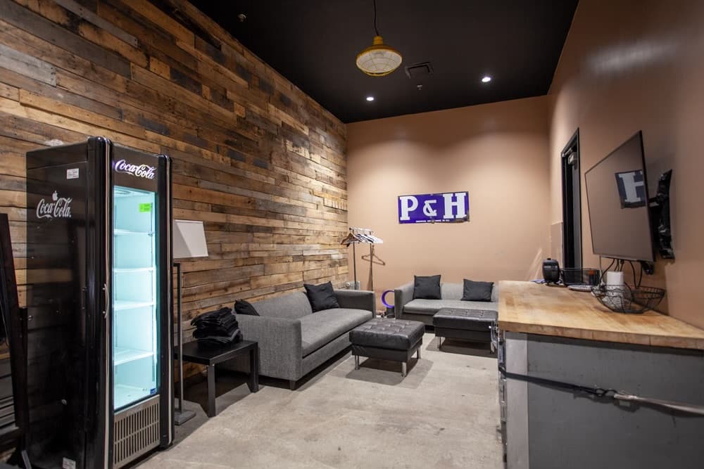 Backstage lounge with a reclaimed-wood feature wall