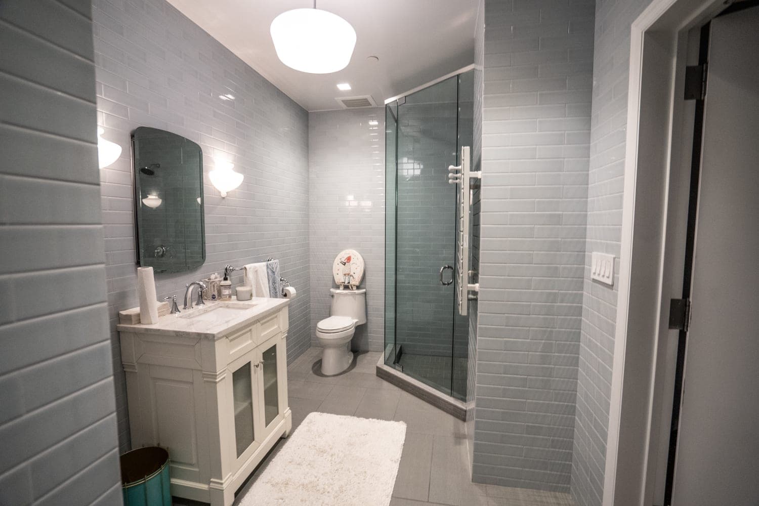 Completed tiled bathroom with glass shower enclosure