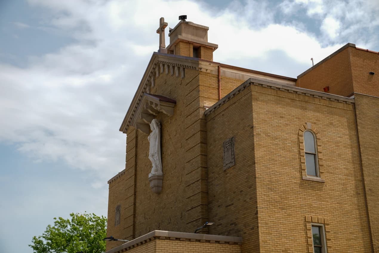 Restored brick elevation, cornice, and devotional statue at St. Sebastian RC Church