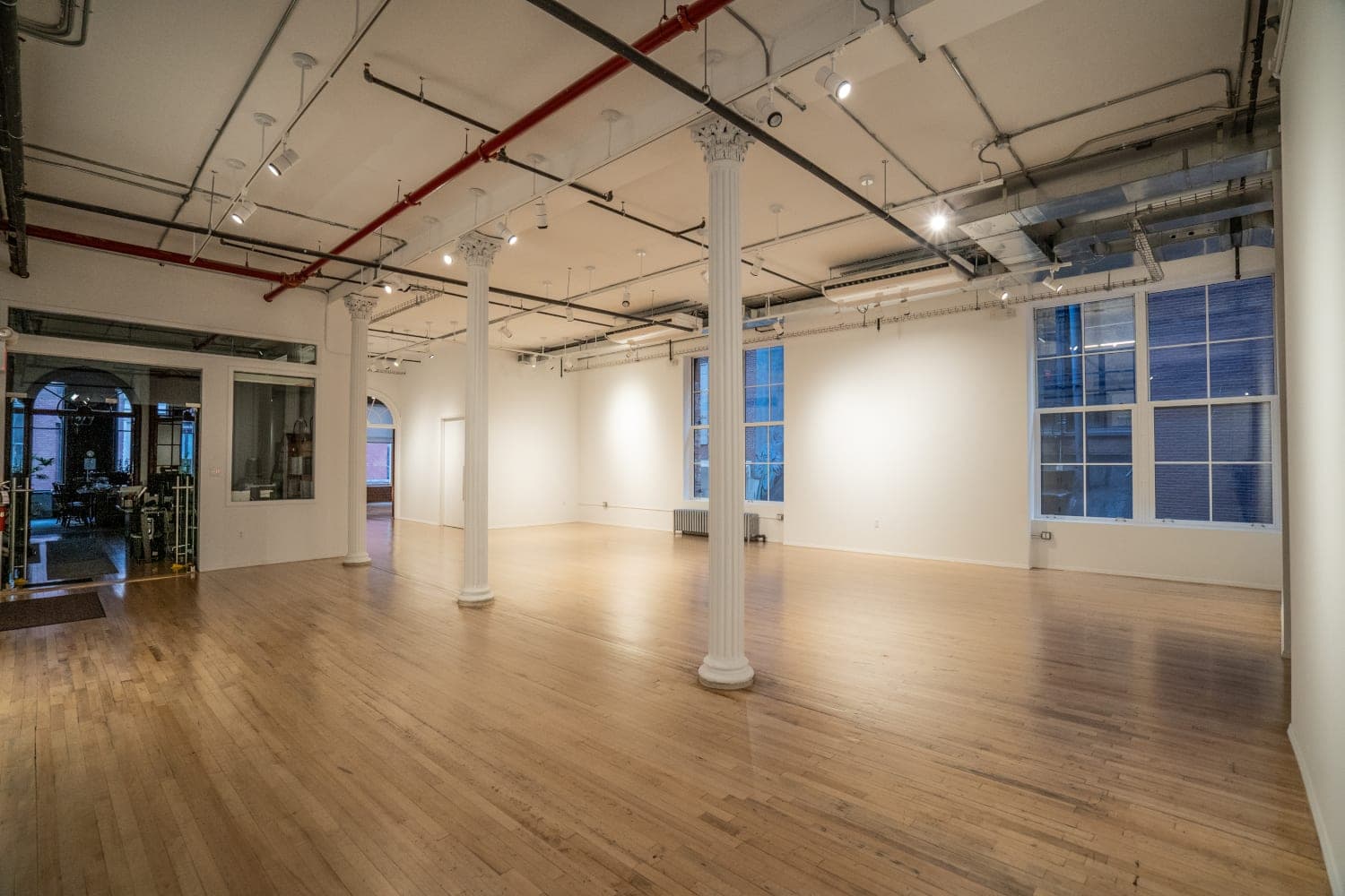 Completed open interior with refinished floors and historic columns
