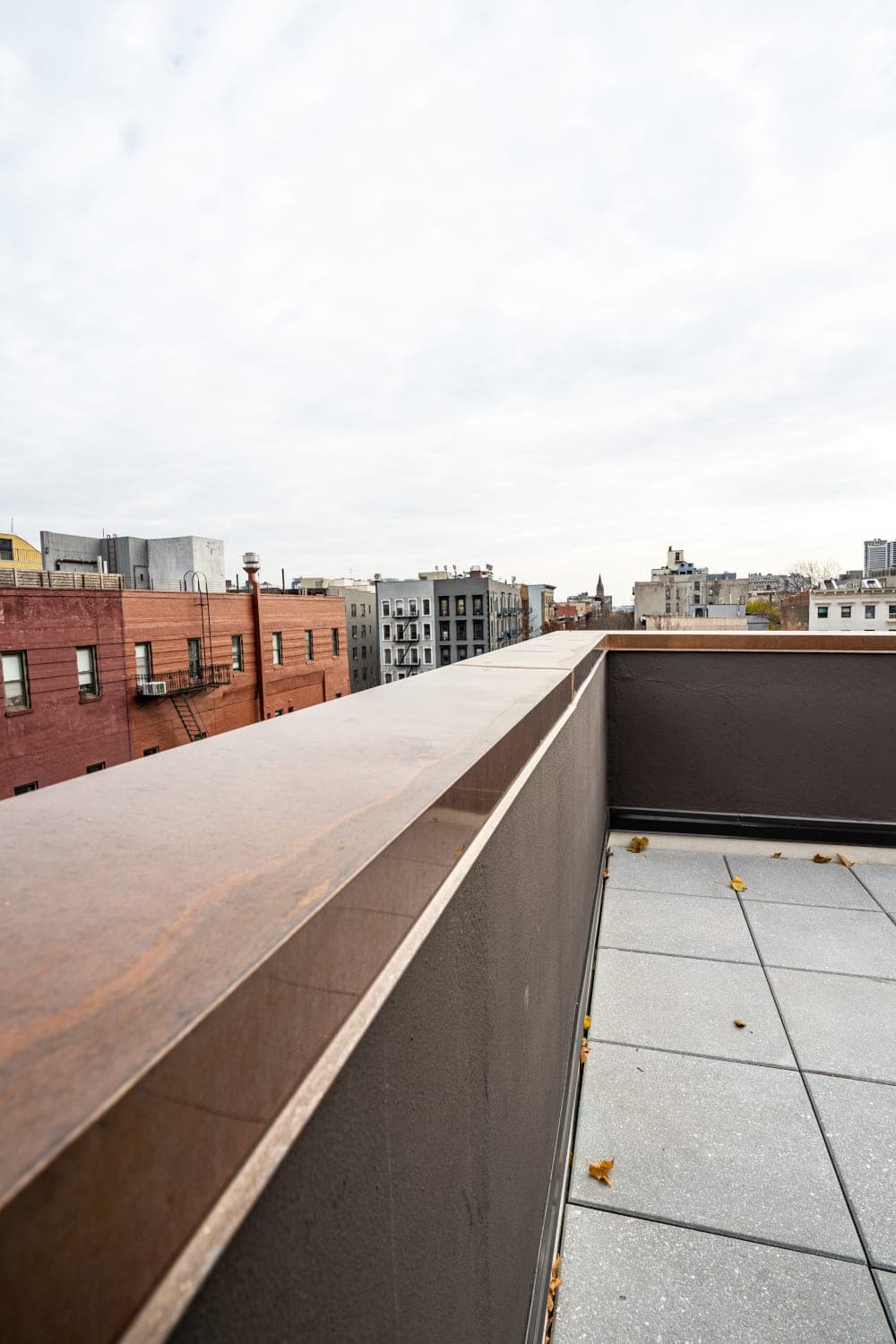 Waterproofed parapet and metal coping at the roof terrace