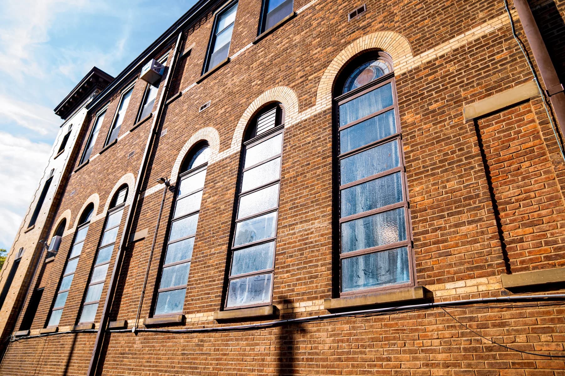 Restored brick façade and arched windows at St. Matthias Church